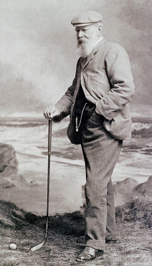 Old Tom Morris on the Old Course at St Andrews in 1901, in a flat cap and tweed jacket