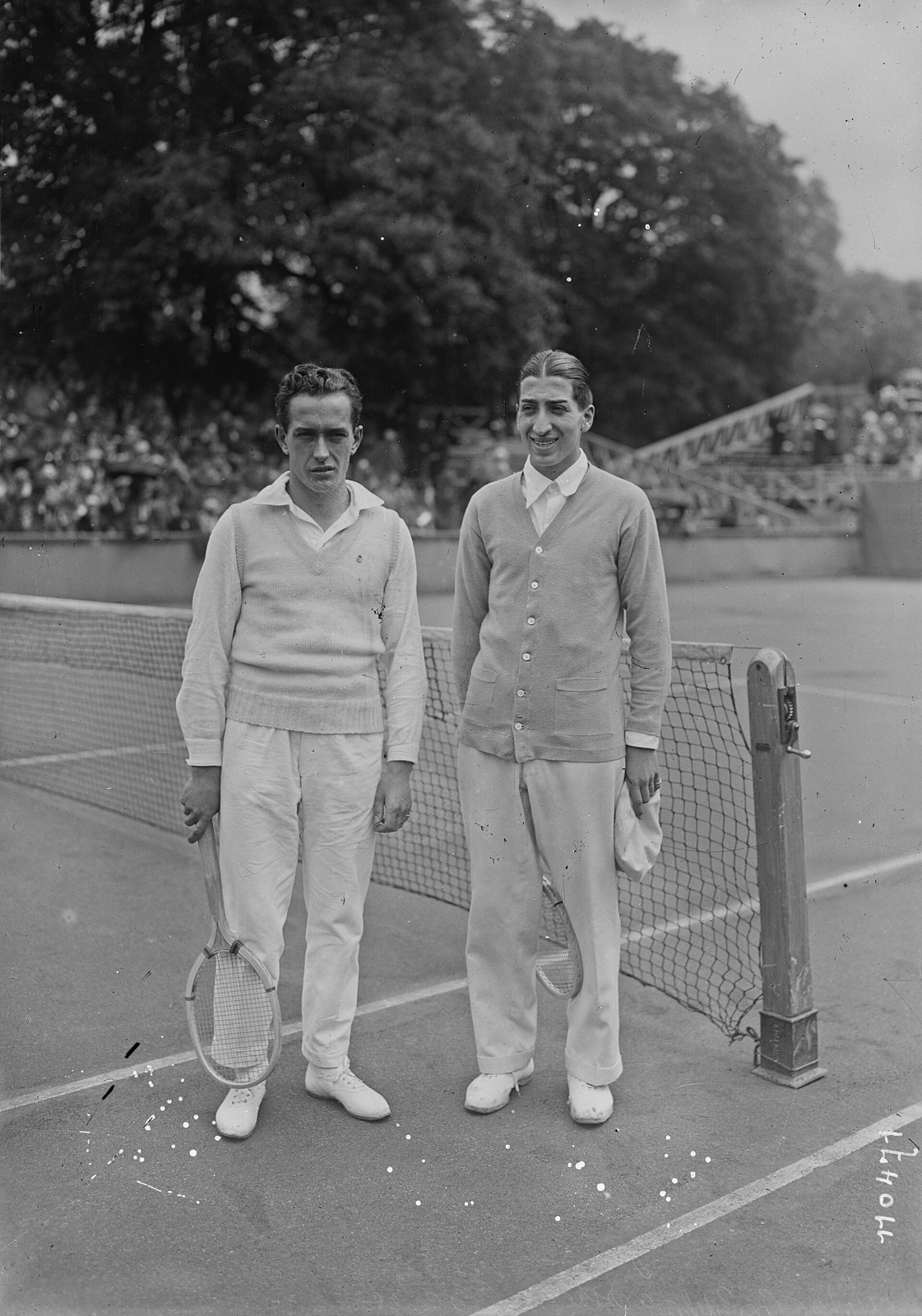 René Lacoste and Henri Cochet on court in 1926 in white knit shirts and flannel trousers